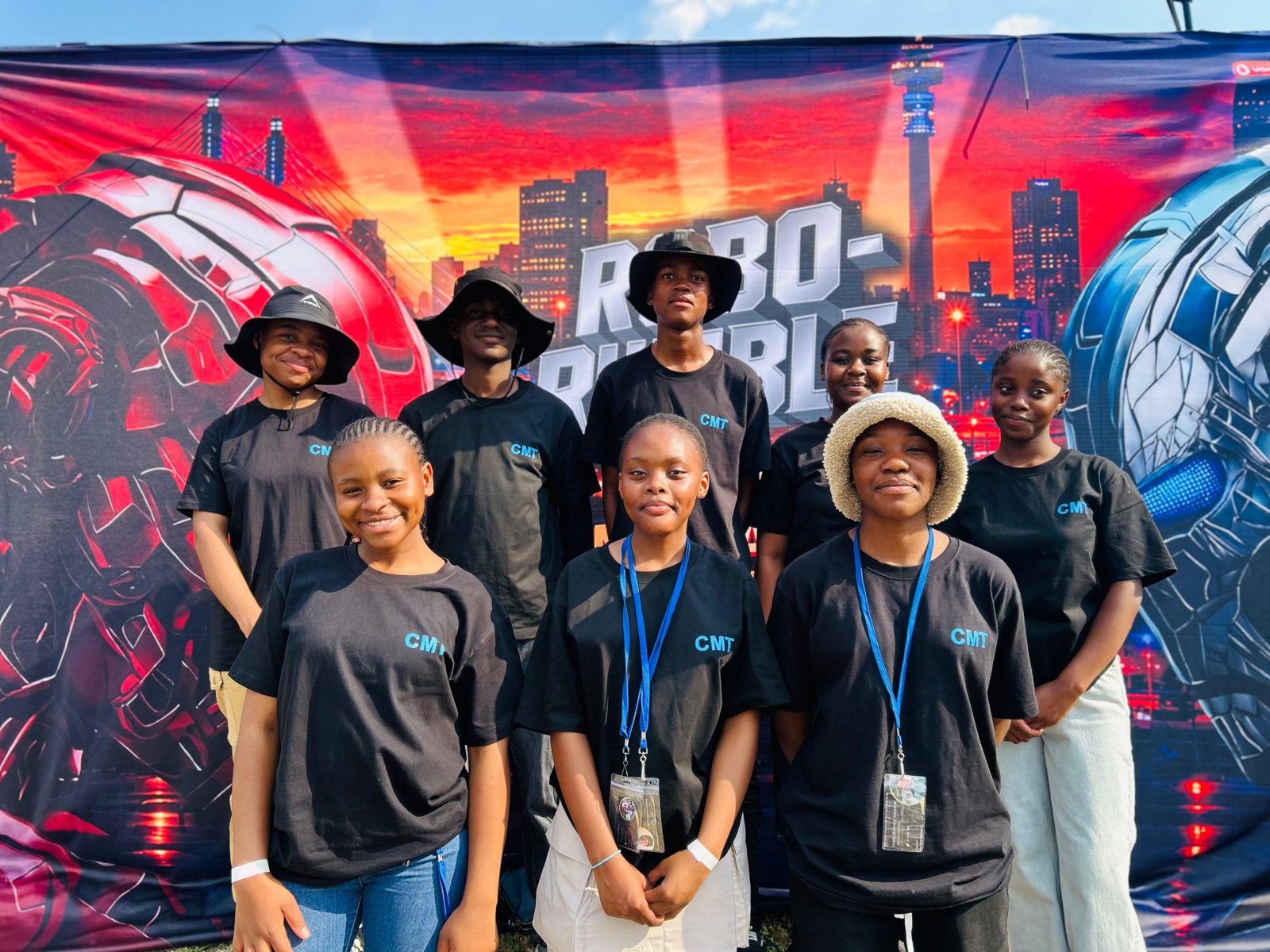 CMT learners in front of the Robo-Rumble banner